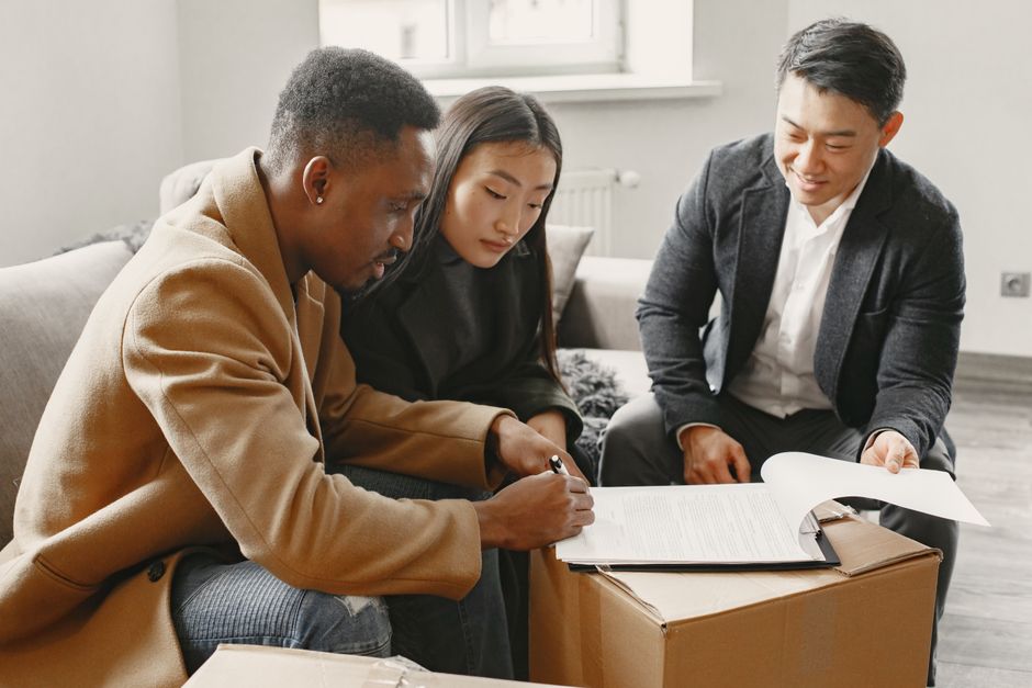 People signing documents together